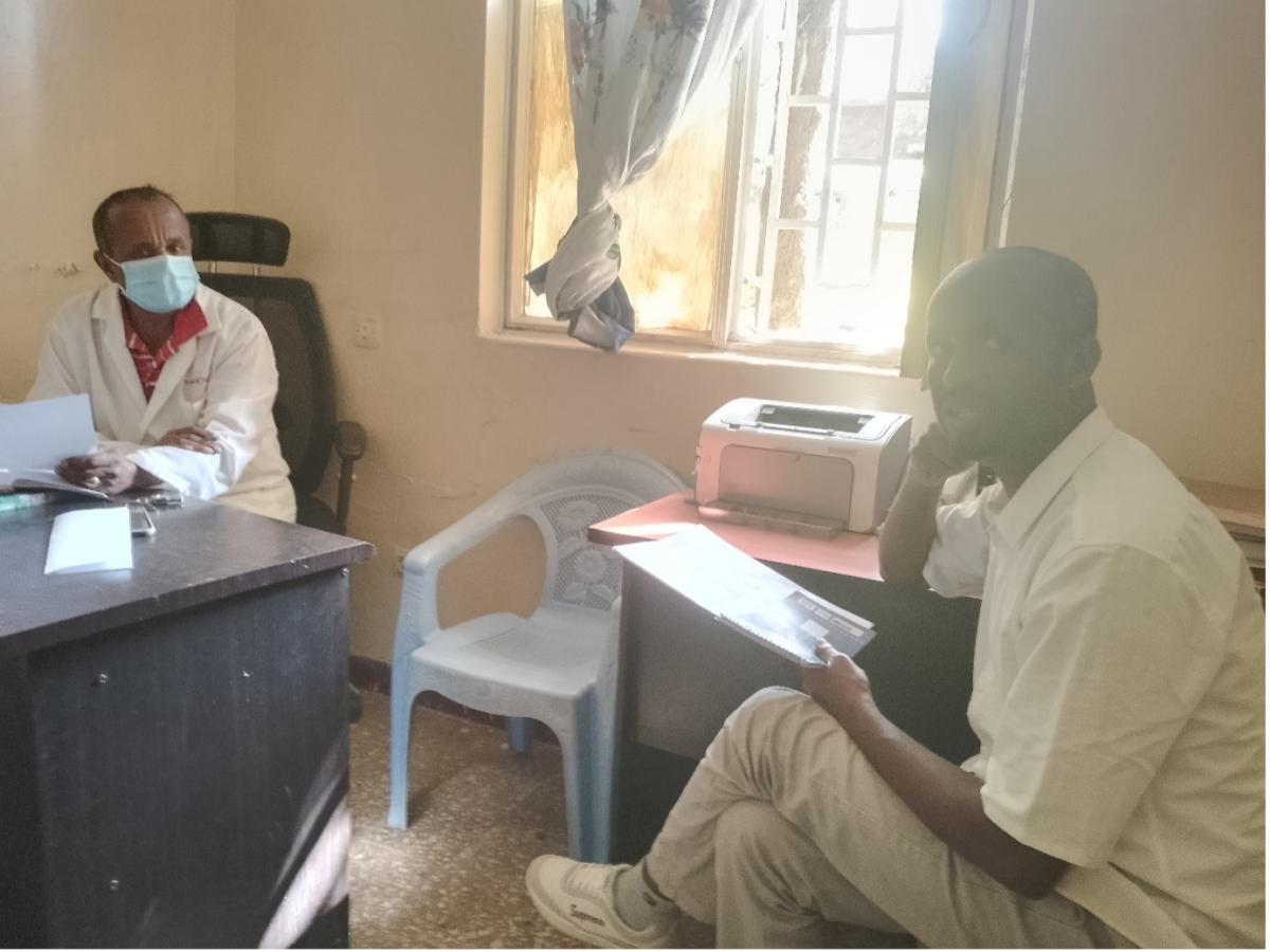 Mr Amare Demmsie, project co-investigator, discussing the research with a health professional at a primary health care centre