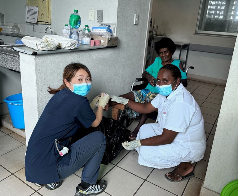 Tomoko Hamada, a nurse volunteer with the Japanese International Cooperation Agency, and Lovelyn Hicky, a nurse at Gizo Hospital, are treating Mrs Siloute. Photo credit: Tomoko Hamada